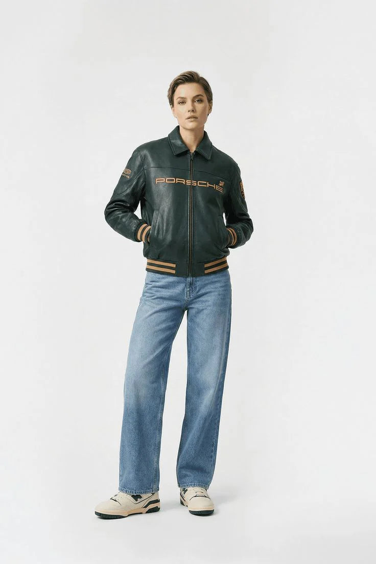 Person wearing a green Porsche jacket and blue jeans on a white background