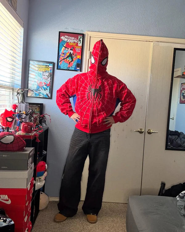 Person wearing a Spider-Man hoodie in a room with superhero-themed decor.
